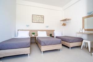 a room with two beds and a mirror at Seaside Resorts in Kavos +23 photos