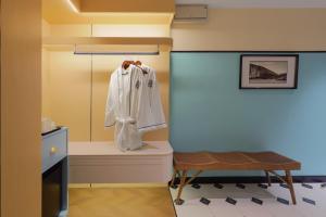 a bathroom with a white robe hanging on a toilet at Hotel Sixty3 in Kota Kinabalu +64 photos