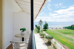 a balcony with a table and a view of the ocean at Seaside Resorts in Kavos