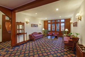 
a living room filled with furniture and a large window at Clarkes hotel, A grand heritage hotel since 1898 in Shimla
