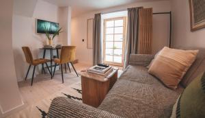 a living room with a couch and a table at Ullinish House in Ullinish
