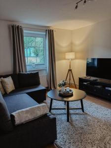 a living room with a couch and a coffee table at Ankerplatz in Leer