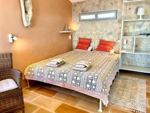 a bedroom with a bed and a chair at Unique Robinson-House with breathtaking seaview in Podšpilje