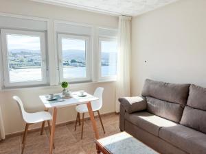 a living room with a couch and a table at Apartamento Brisa by ALÔGA in Corcubión