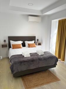 a bedroom with a large bed with two towels on it at Musical Hostel in Albufeira