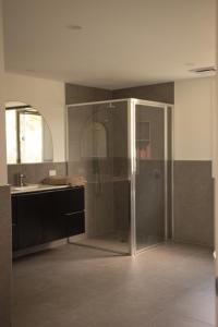 a bathroom with a glass shower and a sink at Agnes homestead in Welshpool +29 photos