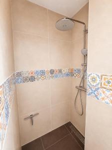 a bathroom with a shower with tiles on the wall at Appartement "Hartje Haamstede" in Burgh Haamstede +31 photos