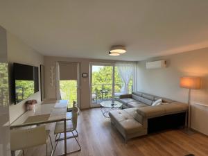 a living room with a couch and a table at Pool & Chill Balaton in Balatonvilágos