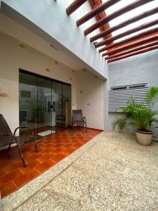 an empty lobby with two chairs and a building at Casa Temporada Espaço Vip in Barra do Garças