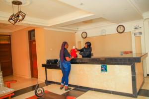 two women standing at a counter in a room at Grand Forty Garden Ltd in Kisumu