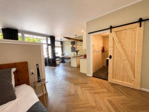 a room with a bed and a sliding barn door at Appartement "Hartje Haamstede" in Burgh Haamstede