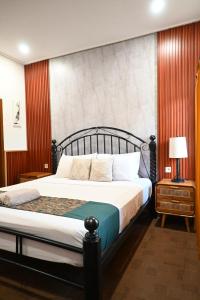 a bedroom with a bed with a large headboard at Chika House in Gili Trawangan