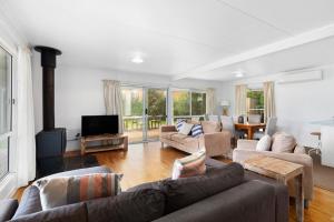 a living room with two couches and a tv at Fennell House in Robe