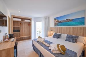 a hotel room with a bed with towels on it at INNER Hotel Rupit "Adults Only" in Cala d´Or