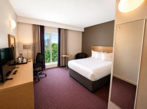 a hotel room with a bed and a television at Leonardo Hotel Derby in Derby