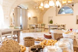 a table with baskets of bread and other foods at Masseria Galleppa by Apulia Hospitality in Monopoli