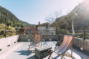 two chairs and a bench on a patio at Agriturismo Valleponci in Finale Ligure