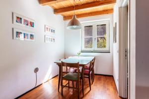 a dining room with a table and chairs and a window at Agriturismo Valleponci in Finale Ligure