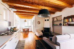 a kitchen and living room with wooden ceilings at Agriturismo Valleponci in Finale Ligure