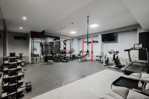 a gym with several treadmills and exercise machines at The Duke Boutique Suites in Athens