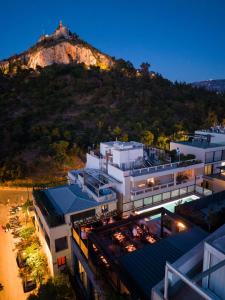 a view of a building with a mountain in the background at The Duke Boutique Suites in Athens