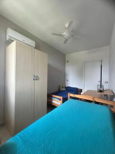 a bedroom with a blue bed and a cabinet at Dimora dei Climiti in Floridia