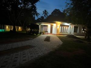 a house with a truck parked in front of it at The Highland Manor in Weligama
