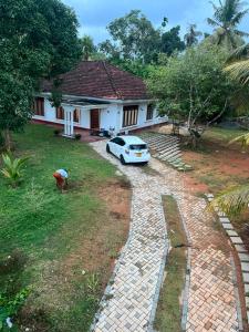 a car parked in front of a house at The Highland Manor in Weligama