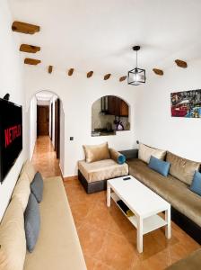 a living room with a couch and a table at Andalucia Cabo in Cabo Negro
