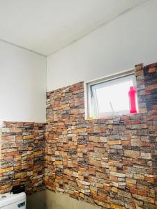 a brick wall in a room with a window at Blue Heaven in Mannar