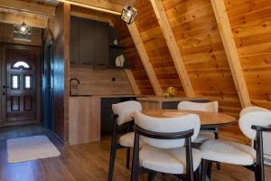 a kitchen and dining room with a table and chairs at Falcon View Zabljak in Žabljak