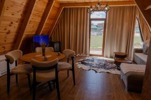 a living room with a table and a couch at Falcon View Zabljak in Žabljak