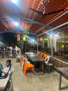 a boy sitting at a table in a restaurant at Sai beach Resort in Diveagar