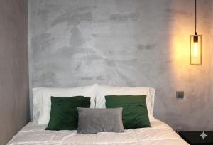 a bed with two green pillows in a bedroom at Fisherman's View in Aveiro +14 photos