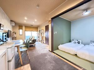 a room with a bed and a desk and a kitchen at Vieuno Hida Takayama 5-Min Walk to Station, Cozy Local Stay in Takayama
