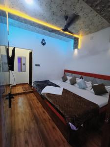 a bedroom with two beds and a large window at Hotel shree jagannath palace in Ujjain