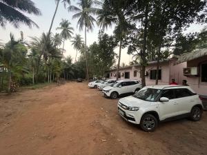 a group of cars parked on a dirt road at Sai beach Resort in Diveagar