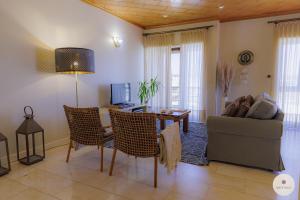a living room with a couch and a table and chairs at Apartamento Ruy Belo - Foz in Vila do Conde