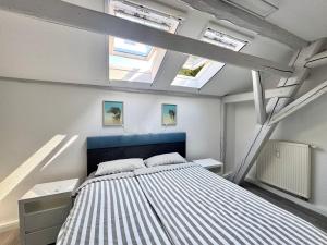 a bedroom with a bed and two skylights at Brauhaus Suite 20 in Sebnitz