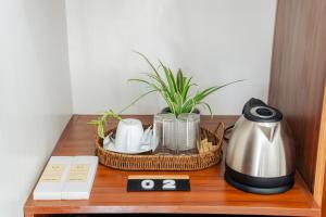 a table with a coffee pot and a tea kettle at Casa Lucia Resort Hotel in Oslob