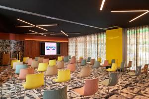 a conference room with chairs and a projection screen at Mama Shelter Dubai in Dubai +136 photos