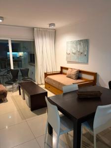 a bedroom with a bed and a table and chairs at Green Park in Punta del Este