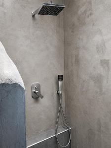 a shower in a bedroom with a shower head at Nova Ledeza NL II in Igoumenitsa
