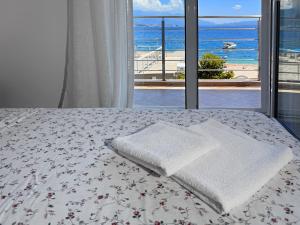 a bedroom with a bed with a view of the ocean at Apartment Orange Blossom First Line & Pool 1 in Bijela +30 photos
