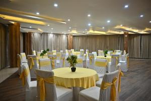 a banquet hall with white tables and white chairs at The Hoften Blue Magnets, Dalhousie in Dalhousie