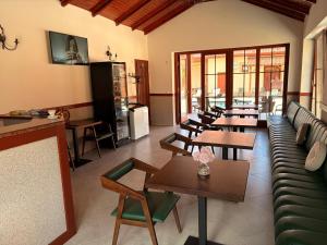 a room with tables and couches and tables and chairs at Bereg-Travel in Berehove