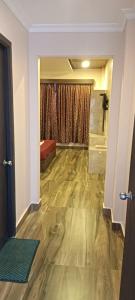 a room with a hallway with a room with a wooden floor at Hotel sunrise in Kodaikānāl