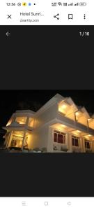 a picture of a house with lights on it at Hotel sunrise in Kodaikānāl