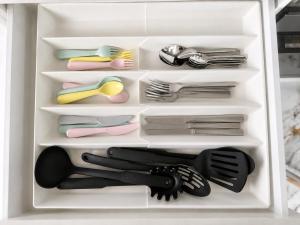 a refrigerator filled with lots of dishes and utensils at Modern Private Granny Flat Free Parking in Riverstone