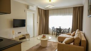a living room with a couch and a table at Er Suite in Alanya